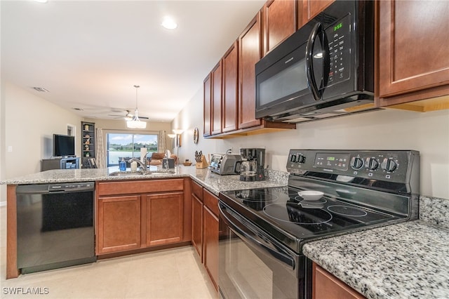 kitchen with light stone countertops, ceiling fan, sink, kitchen peninsula, and black appliances