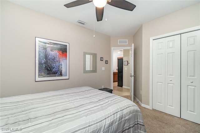 bedroom featuring a closet, ceiling fan, and light colored carpet