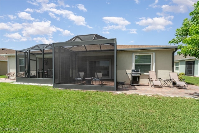 back of property featuring a patio area, a lawn, and a lanai