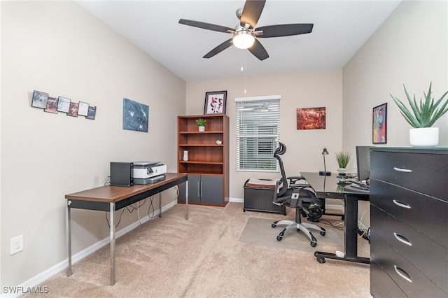 office space with ceiling fan and light carpet