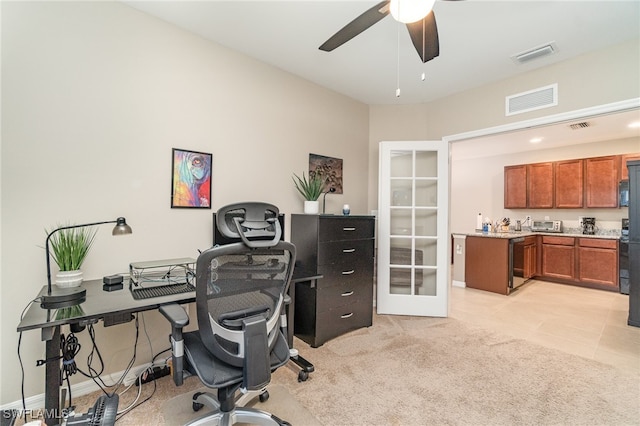 carpeted home office with ceiling fan and french doors