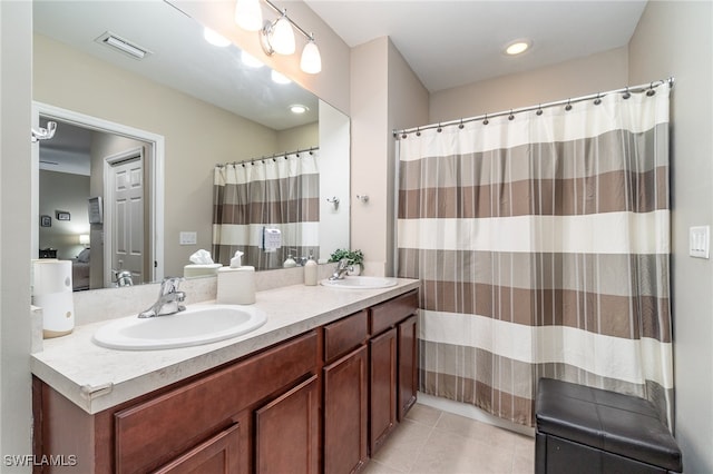 bathroom with tile patterned flooring and vanity