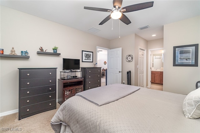 carpeted bedroom featuring ensuite bath and ceiling fan