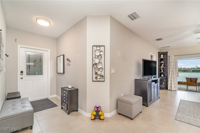 tiled entryway with ceiling fan