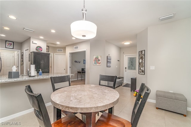 dining space featuring light tile patterned floors