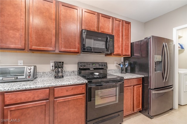 kitchen featuring black appliances and light stone countertops