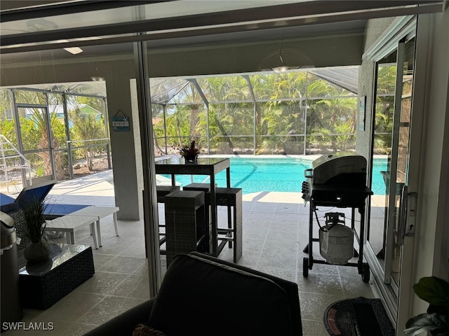 view of swimming pool with glass enclosure, area for grilling, and a patio