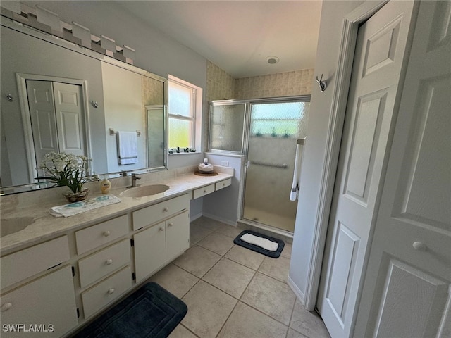 bathroom featuring vanity, an enclosed shower, and tile patterned flooring