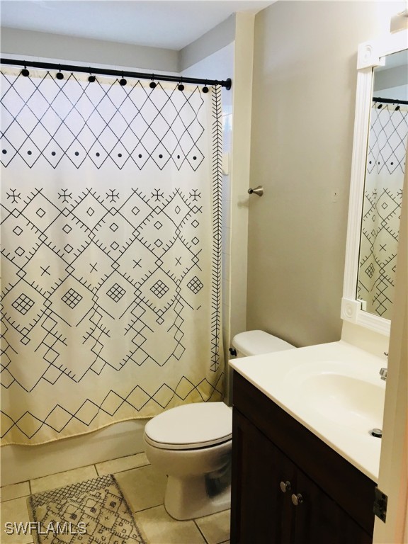 bathroom featuring tile patterned flooring, vanity, and toilet