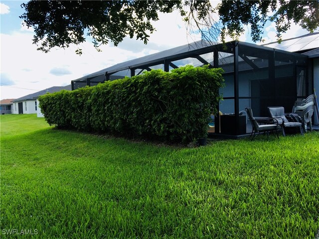 view of yard featuring glass enclosure