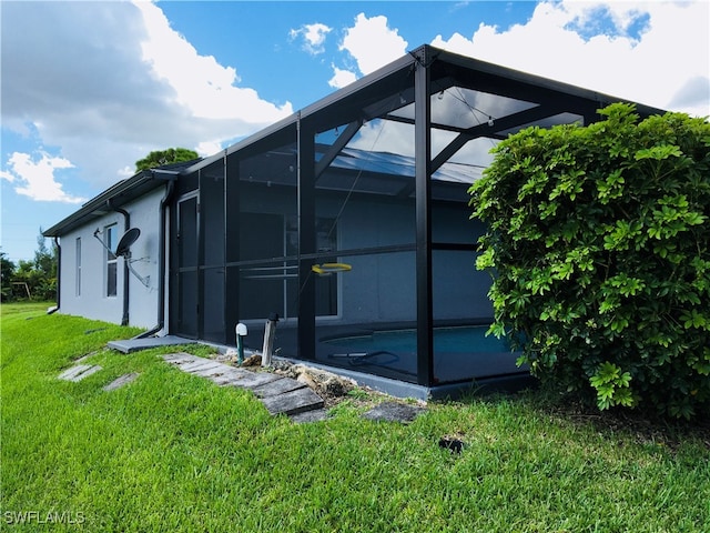 view of property exterior featuring a yard and a lanai