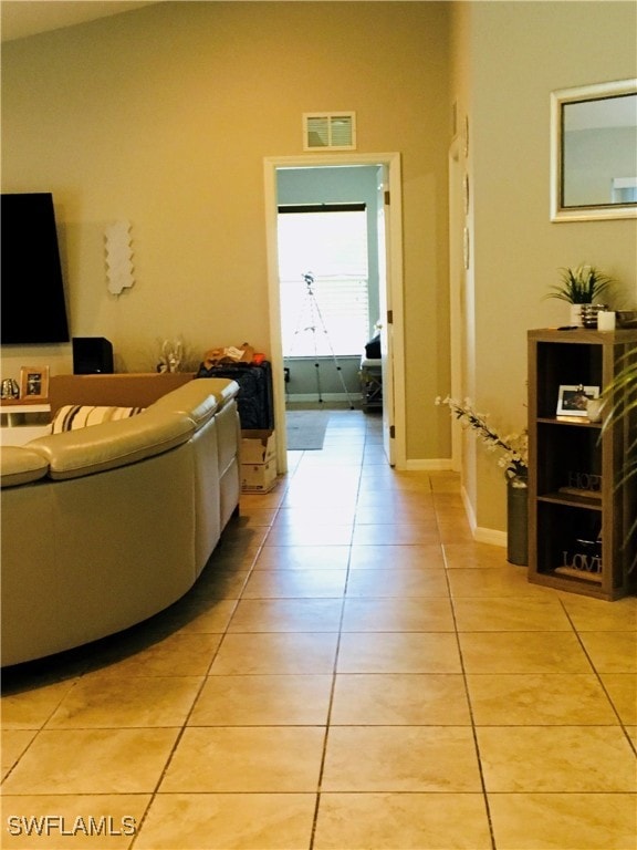 tiled living room featuring lofted ceiling