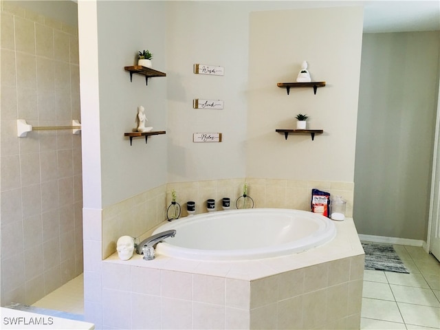 bathroom featuring tile patterned flooring and a relaxing tiled tub