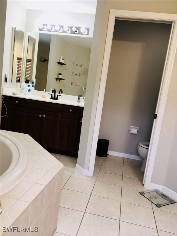 bathroom featuring vanity, toilet, tile patterned floors, and a relaxing tiled tub