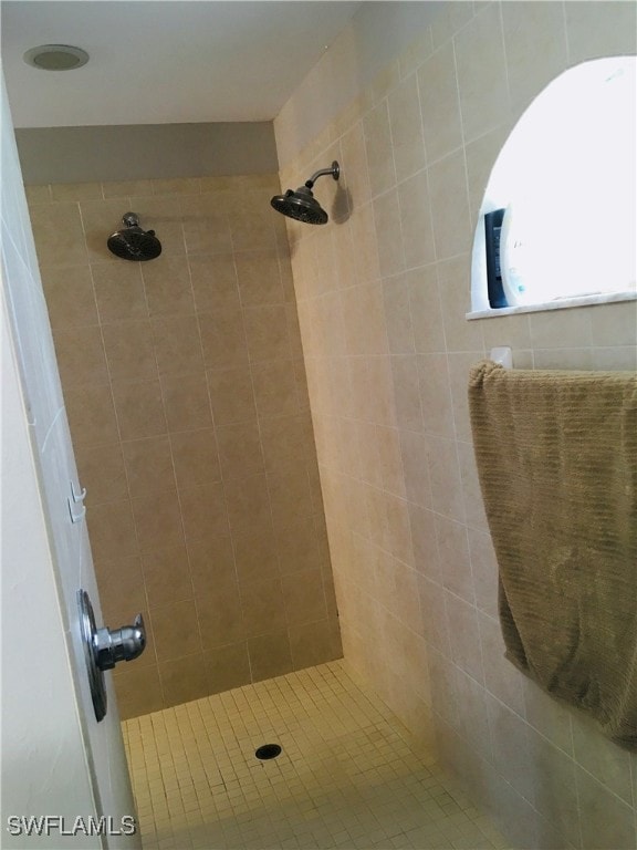 bathroom with a tile shower