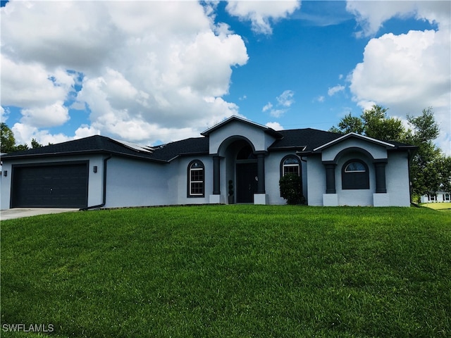 ranch-style house featuring a garage and a front yard