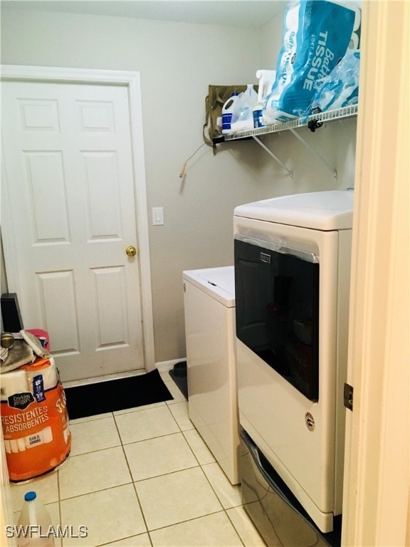 laundry room with separate washer and dryer and light tile patterned floors