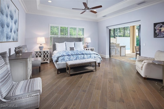 bedroom with multiple windows, a raised ceiling, ceiling fan, and dark wood-type flooring