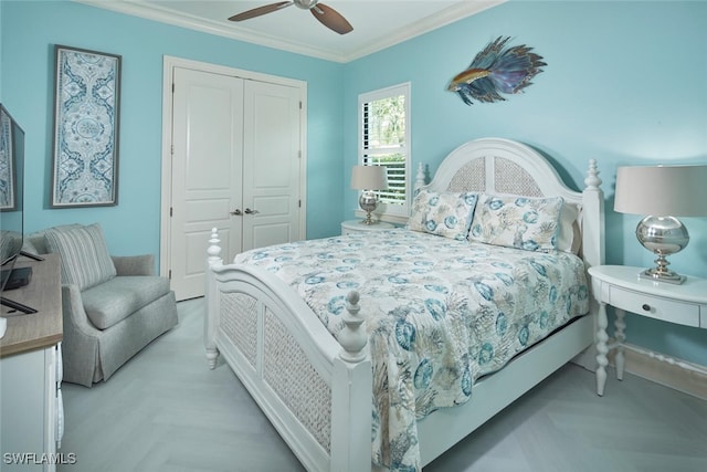 bedroom with ornamental molding, light parquet floors, ceiling fan, and a closet