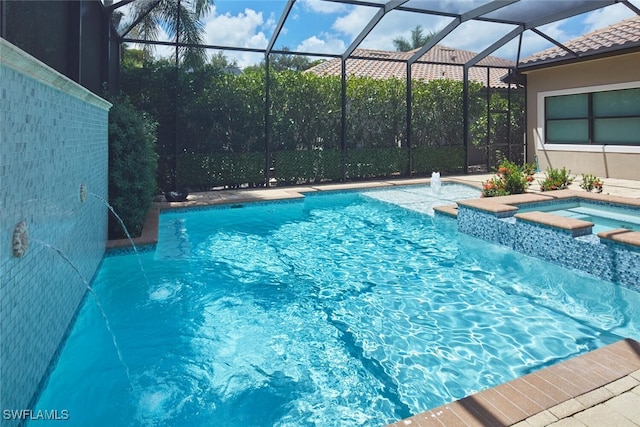 view of swimming pool with an in ground hot tub, pool water feature, and a lanai