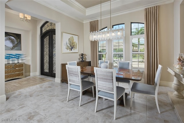 23778 Campla Ct, Estero, FL 34134 - dining room with baseboards, a towering ceiling, an inviting chandelier, a tray ceiling, and crown molding