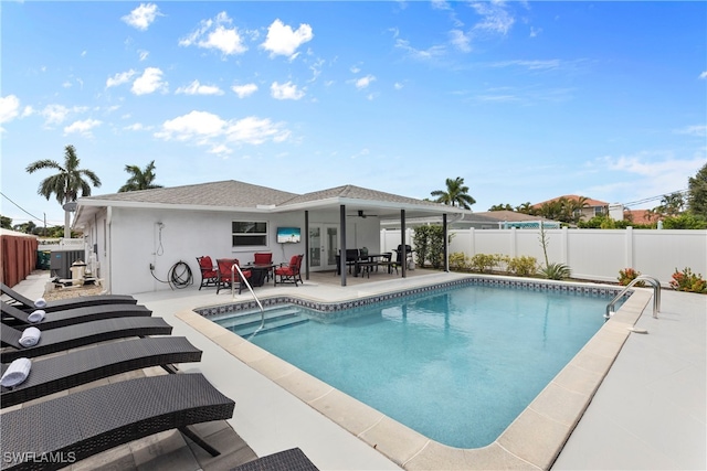 view of swimming pool with ceiling fan and a patio area