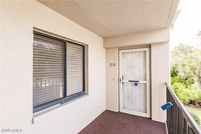 entrance to property featuring a balcony