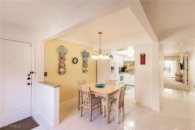 dining space featuring light tile patterned floors, a chandelier, and ornamental molding