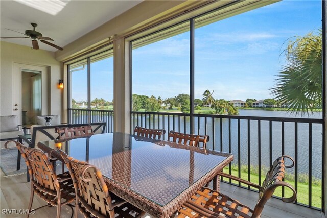 sunroom / solarium featuring plenty of natural light, a water view, and ceiling fan