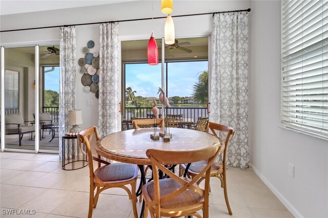 dining space with ceiling fan and light tile patterned flooring