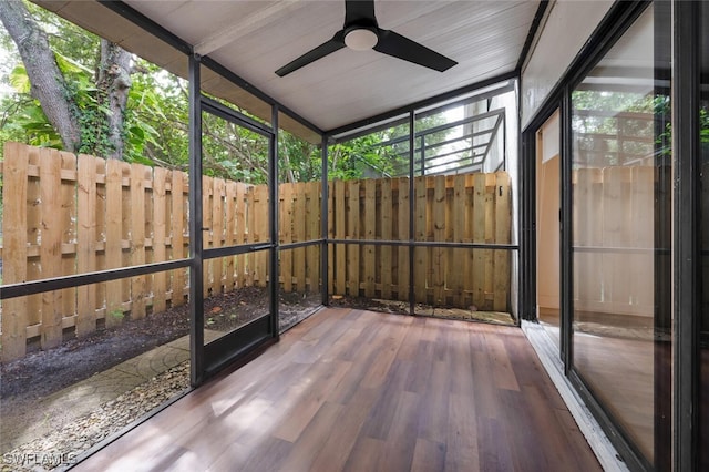 unfurnished sunroom with a ceiling fan and a wealth of natural light