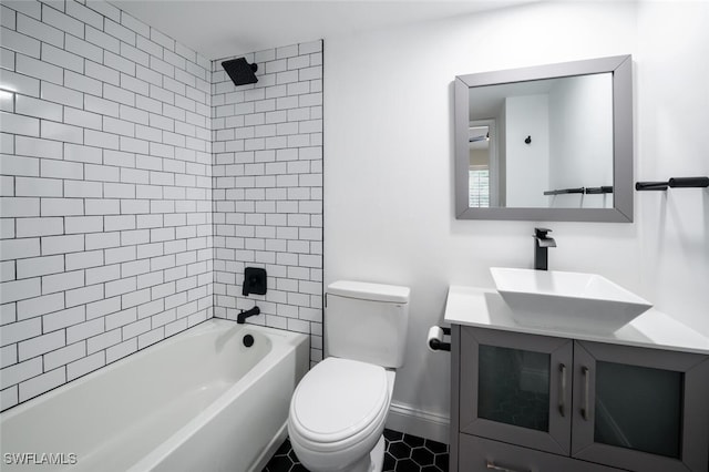 bathroom featuring shower / bathing tub combination, toilet, vanity, tile patterned flooring, and baseboards