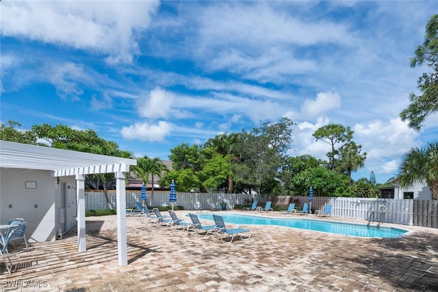 community pool featuring a patio area, fence, and a pergola