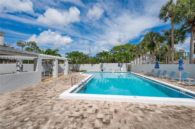 pool with a patio, a fenced backyard, and a pergola