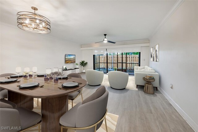 dining area with a chandelier, ornamental molding, wood finished floors, and baseboards