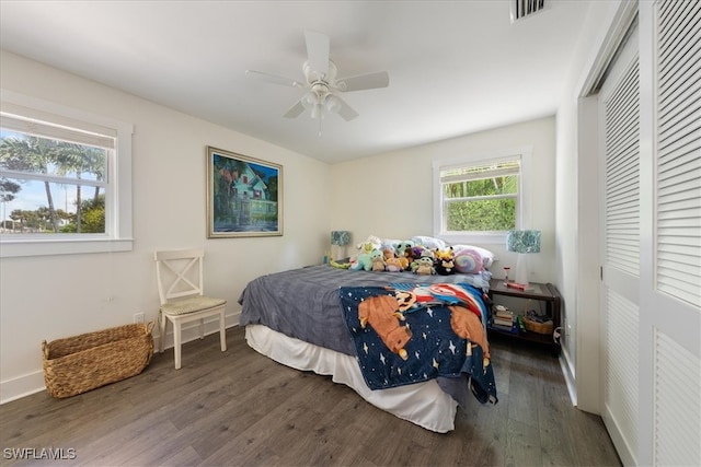 bedroom featuring a closet, ceiling fan, and dark hardwood / wood-style floors