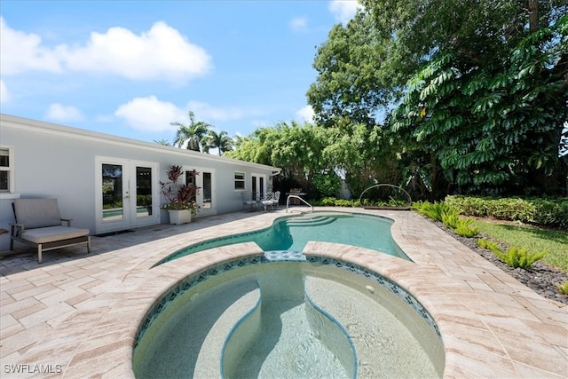 view of pool with a patio, an in ground hot tub, and french doors