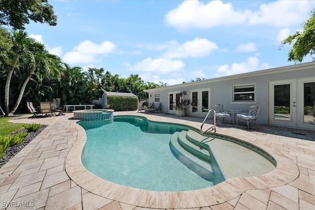 view of pool featuring a patio and french doors