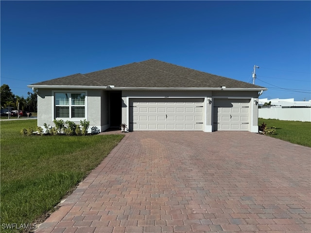 view of front of home featuring a garage and a front yard