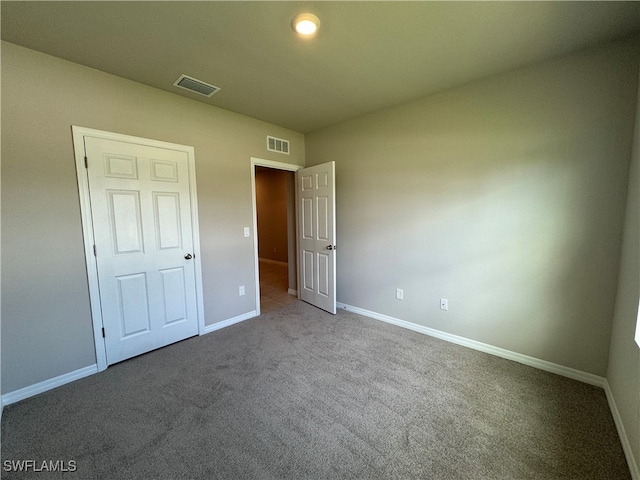 unfurnished bedroom with a closet and carpet floors