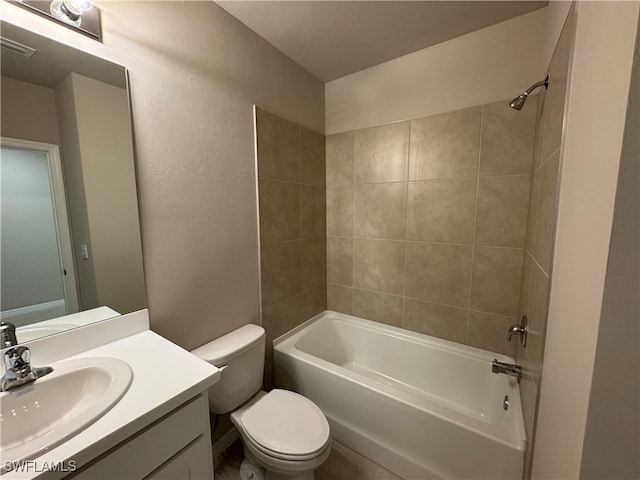 full bathroom with vanity, toilet, and tiled shower / bath combo