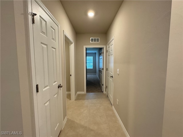 hall featuring light tile patterned floors