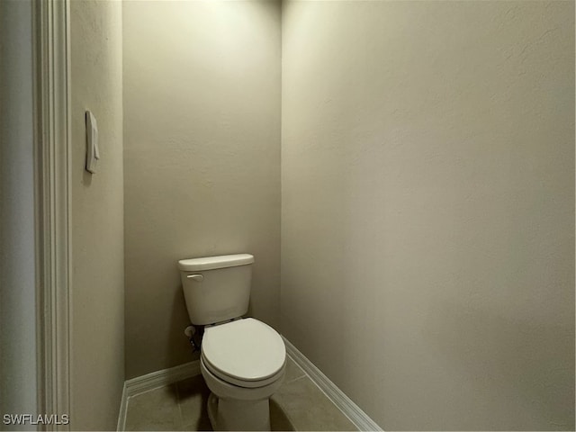 bathroom featuring toilet and tile patterned floors