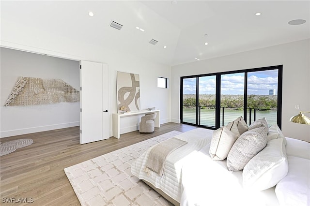 bedroom with access to exterior, lofted ceiling, and wood-type flooring