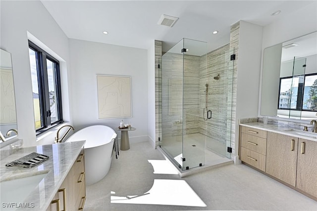 bathroom featuring separate shower and tub and vanity