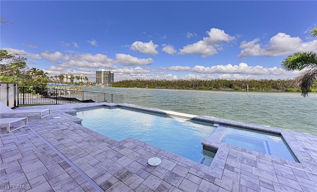 view of pool with a water view, an in ground hot tub, and a patio