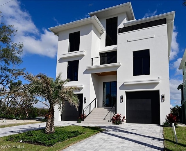 contemporary home with a balcony and a garage