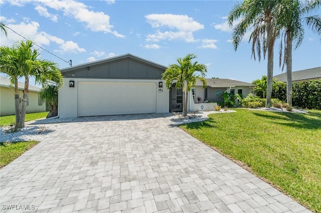 single story home with a front yard and a garage