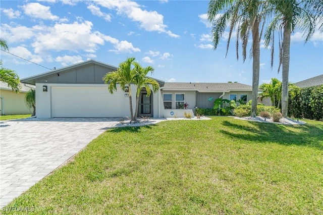 single story home with a front yard and a garage