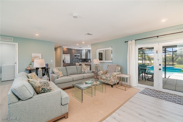 living room with light hardwood / wood-style flooring